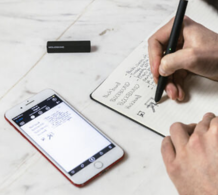 Smart Notebook (large) with Ncoded paper designed to work with Smart Pen, rounded corners, elastic closure and matching ribbon bookmark; ivory-colored, 100 g/m², acid-free paper: ruled. 'In case of loss' printed on the flyleaf, expandable inner pocket in the back. Lies flat, opens at 180°